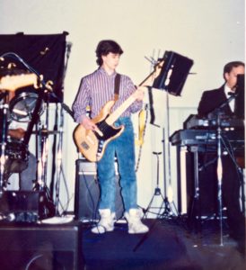 A teenage Damian Coccio playing bass guitar