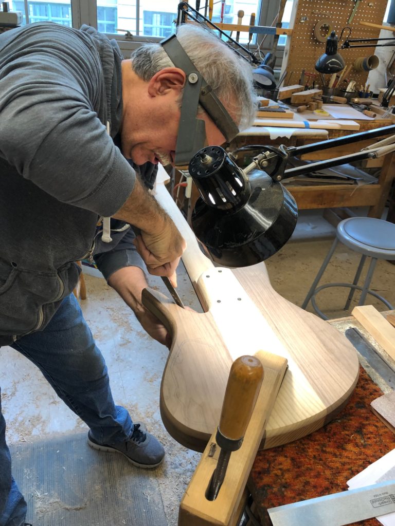 Vinny Fodera carving the bass body
